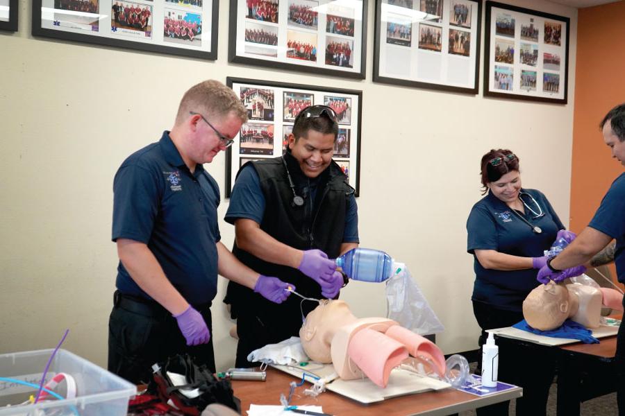 Multiple students practicing on dummies